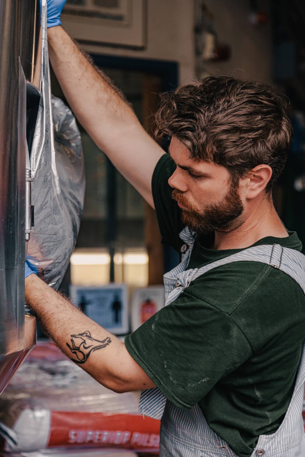 man make emptying a sack of malt