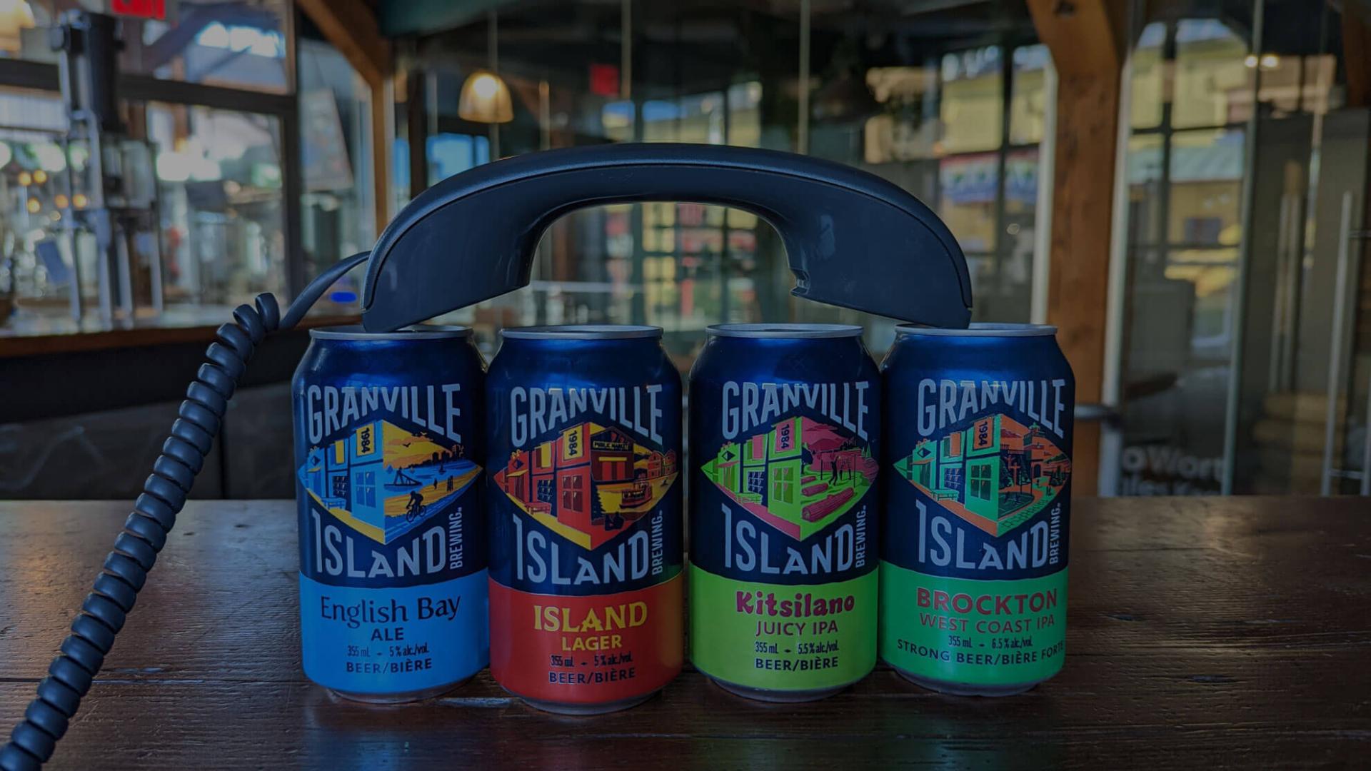 Phone in granville beer cans on a bar