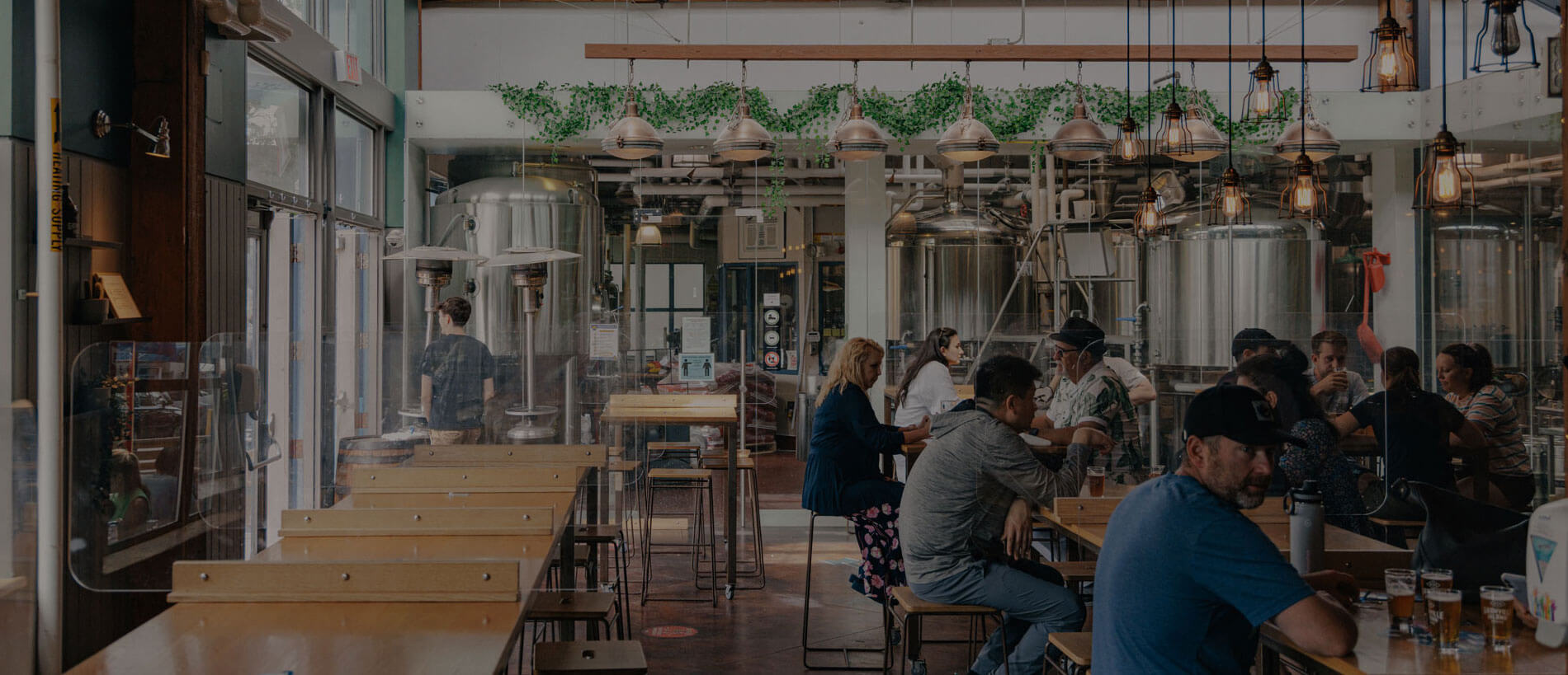 people seated at a table in the Granville brewery