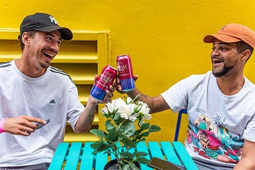 friends bumping cans smiling