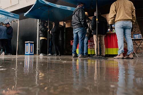 persons bellow umbrellas front a granville stand
