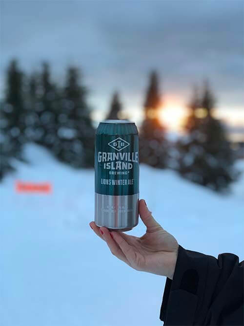 granville can in a hand with snow background