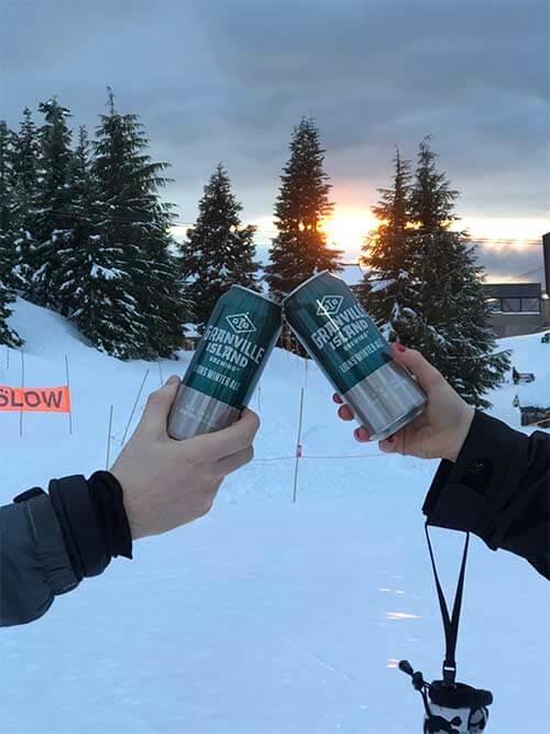 two granville cans in a hands with snow background