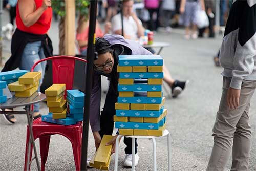 girl building jenga tower