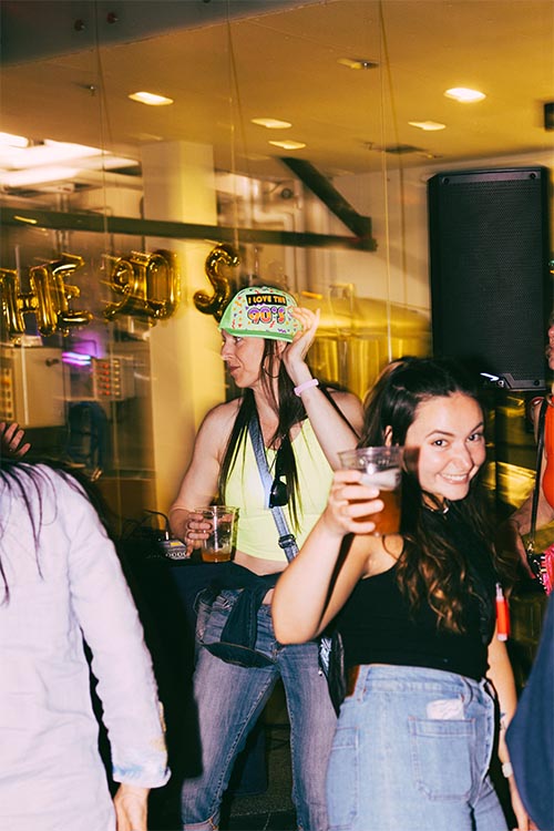 person dancing, and girl posing with a granville beer for photo