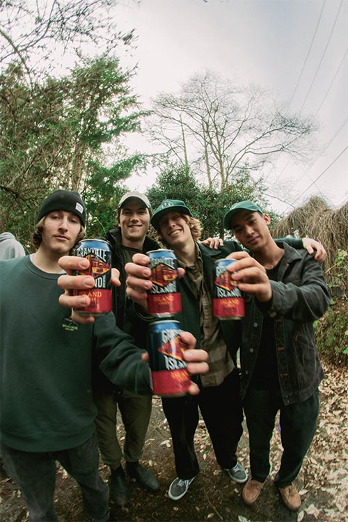 friends posing for photo in the forest with granville can in hands