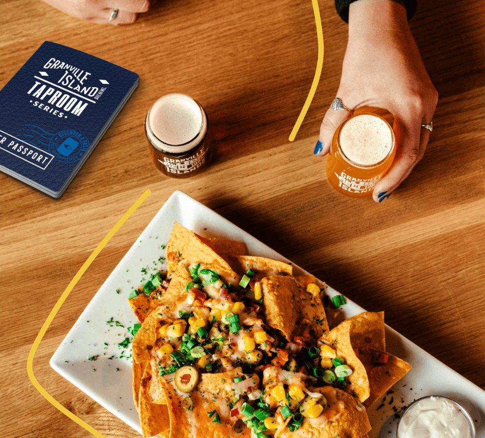 nachos, beer passport and a hand with granville beer glass on a table